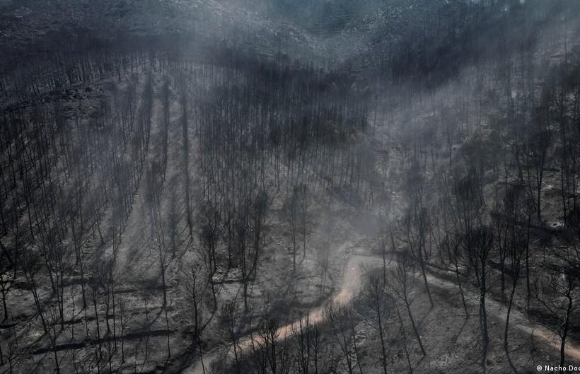 Spain battles forest fire a short drive from flash flood